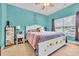 Comfortable bedroom with a decorative sunflower bed frame, ceiling fan, and soothing turquoise walls at 1001 Dinger Ct. # 1001, Myrtle Beach, SC 29588