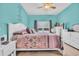 Cozy bedroom featuring a queen bed, soft carpet, natural light, and relaxing turquoise walls with inspirational decor at 1001 Dinger Ct. # 1001, Myrtle Beach, SC 29588