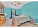Cozy bedroom featuring a ceiling fan, bright turquoise walls, and comfortable furnishings at 1001 Dinger Ct. # 1001, Myrtle Beach, SC 29588