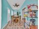 Bright dining room with wooden table, a ceiling fan, and ample storage, with turquoise accent walls at 1001 Dinger Ct. # 1001, Myrtle Beach, SC 29588