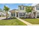 Inviting townhome featuring stone detailing, a well-kept lawn, and a welcoming front entrance at 1001 Dinger Ct. # 1001, Myrtle Beach, SC 29588