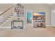 Inviting foyer with staircase and view into the bedroom featuring a mounted television at 1001 Dinger Ct. # 1001, Myrtle Beach, SC 29588