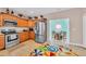 Well-equipped kitchen boasts stainless steel appliances, wood cabinets, and a breakfast area with a vibrant rug at 1001 Dinger Ct. # 1001, Myrtle Beach, SC 29588
