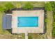 Aerial view of a sparkling community pool with clear blue water, surrounded by lush landscaping and a secure fence at 1001 Dinger Ct. # 1001, Myrtle Beach, SC 29588