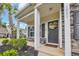 Welcoming front porch with decorative wreath, stone accents, and manicured landscaping at 1001 Dinger Ct. # 1001, Myrtle Beach, SC 29588