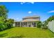 Spacious backyard with patio area, screened-in porch, well-manicured lawn and manicured landscaping at 1007 Oak Marsh Ln., North Myrtle Beach, SC 29582