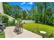 Well-maintained backyard with patio seating, lush lawn, white fence, and mature trees at 1007 Oak Marsh Ln., North Myrtle Beach, SC 29582
