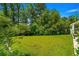 Lush backyard featuring a sprawling green lawn surrounded by mature trees and natural landscape at 1007 Oak Marsh Ln., North Myrtle Beach, SC 29582