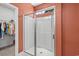 Bright bathroom with a walk-in closet and modern glass enclosed shower with bright white tile at 1007 Oak Marsh Ln., North Myrtle Beach, SC 29582