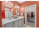 Elegant bathroom featuring a double vanity, a walk-in closet, and neutral tile flooring at 1007 Oak Marsh Ln., North Myrtle Beach, SC 29582