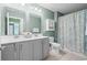 Inviting bathroom with a double vanity, modern fixtures, and a shower featuring a bright, patterned curtain at 1007 Oak Marsh Ln., North Myrtle Beach, SC 29582