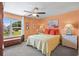 Cozy bedroom with a plush bed, warm peach-colored walls, and a window view of lush greenery at 1007 Oak Marsh Ln., North Myrtle Beach, SC 29582
