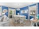 Bright dining area featuring a white table and chair set, blue walls and modern chandelier lighting at 1007 Oak Marsh Ln., North Myrtle Beach, SC 29582