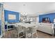 Open-concept dining area with blue accent wall, wooden floors and modern chandelier at 1007 Oak Marsh Ln., North Myrtle Beach, SC 29582