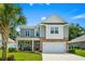 Inviting two-story home with a red front door, a cozy porch, and a two-car garage at 1007 Oak Marsh Ln., North Myrtle Beach, SC 29582