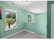 Hallway space bathed in natural light, showcasing a serene, light-green color scheme and carpeted floor at 1007 Oak Marsh Ln., North Myrtle Beach, SC 29582