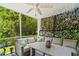 Relaxing screened porch with ceiling fan, comfortable seating, and decorative lattice privacy screen at 1007 Oak Marsh Ln., North Myrtle Beach, SC 29582