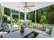Inviting screened porch featuring cozy seating, a ceiling fan, and views of the lush backyard at 1007 Oak Marsh Ln., North Myrtle Beach, SC 29582