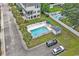 Aerial view of the neighborhood pool and surrounding properties with lush landscaping and parking at 1011 Sable Palm Way, Surfside Beach, SC 29575