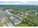 An aerial view shows proximity to shopping, lush greenery, and nearby beach at 1011 Sable Palm Way, Surfside Beach, SC 29575