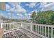 Relaxing balcony with wicker furniture and scenic neighborhood views on a sunny day at 1011 Sable Palm Way, Surfside Beach, SC 29575