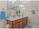 Bathroom featuring a double sink vanity with updated fixtures, spacious countertop, and bright lighting at 1011 Sable Palm Way, Surfside Beach, SC 29575