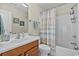 Bathroom with shower/tub combo and vanity, showcasing bright lighting and modern fixtures at 1011 Sable Palm Way, Surfside Beach, SC 29575