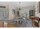 Dining room featuring elegant chandelier, hardwood floors, and large windows for ample natural lighting at 1011 Sable Palm Way, Surfside Beach, SC 29575