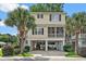 Charming raised beach home with two-story design, screened porch, and ground-level parking at 1011 Sable Palm Way, Surfside Beach, SC 29575