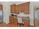 Bright kitchen featuring custom cabinets, granite counters, hardwood floors and adjacent nook with built-in desk at 1011 Sable Palm Way, Surfside Beach, SC 29575