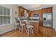 Charming kitchen featuring a breakfast bar, hardwood floors, stainless steel appliances and plenty of cabinet space at 1011 Sable Palm Way, Surfside Beach, SC 29575