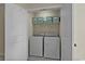Convenient laundry room features a washer and dryer, overhead storage, and tile flooring at 1011 Sable Palm Way, Surfside Beach, SC 29575