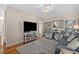 Cozy living room boasting hardwood floors, modern furniture, a ceiling fan, and lots of natural light at 1011 Sable Palm Way, Surfside Beach, SC 29575