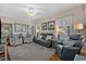 Comfortable living room with ceiling fan, hardwood floors, modern furniture, and bright natural light at 1011 Sable Palm Way, Surfside Beach, SC 29575