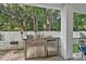 Covered outdoor kitchen area with a stainless steel grill, built-in storage, and a small refrigerator at 1011 Sable Palm Way, Surfside Beach, SC 29575