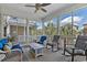Relaxing screened-in porch with comfortable wicker furniture, ceiling fan, and neighborhood views at 1011 Sable Palm Way, Surfside Beach, SC 29575
