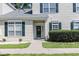 Charming townhome entrance with green shutters and a decorative wreath at 106 Scotch Broom Dr. # 105, Little River, SC 29566