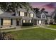 Charming townhome with green shutters and well-manicured lawn at dusk at 106 Scotch Broom Dr. # 105, Little River, SC 29566