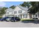 Townhomes with gray roofs, white siding, and green shutters with parking at 106 Scotch Broom Dr. # 105, Little River, SC 29566