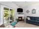 Cozy living room featuring a fireplace, comfortable seating, and access to an outdoor patio at 106 Scotch Broom Dr. # 105, Little River, SC 29566