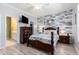 Spacious main bedroom with a wood-accent wall, ensuite bathroom, and walk-in closet at 106 Scotch Broom Dr. # 105, Little River, SC 29566