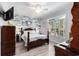 Well-lit main bedroom with a decorative accent wall and a large window overlooking the yard at 106 Scotch Broom Dr. # 105, Little River, SC 29566