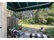 Relaxing patio area with outdoor seating, a wind chime, potted plants, and a view of a serene fenced backyard at 106 Scotch Broom Dr. # 105, Little River, SC 29566