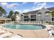 Community pool surrounded by lounge chairs and a covered pavilion, perfect for relaxation and recreation at 106 Scotch Broom Dr. # 105, Little River, SC 29566