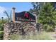 Stone entrance sign reading 'Village at the Glens' with decorative emblem surrounded by lush greenery at 106 Scotch Broom Dr. # 105, Little River, SC 29566