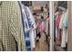 Organized walk-in closet features ample storage with hanging racks, shelving, and a variety of clothes and personal items at 106 Scotch Broom Dr. # 105, Little River, SC 29566