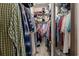 Organized walk-in closet features ample storage with hanging racks, shelving, and a variety of clothes and personal items at 106 Scotch Broom Dr. # 105, Little River, SC 29566