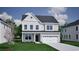 Charming two-story home with a manicured lawn, attached two-car garage, and neutral-toned siding and trim at 1076 Laconic Dr., Myrtle Beach, SC 29588