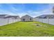 This is a home's backyard with green grass and an off-white fence at 1077 Stoney Falls Blvd., Myrtle Beach, SC 29579