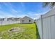 This is a home's backyard with green grass and an off-white fence at 1077 Stoney Falls Blvd., Myrtle Beach, SC 29579